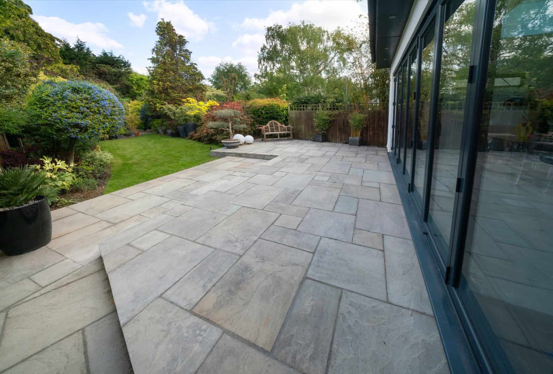 Indian sandstone patio and landscaped garden